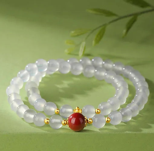 White agate bracelet with jequirity bean and cinnabar beads, 6mm polished geometric shape