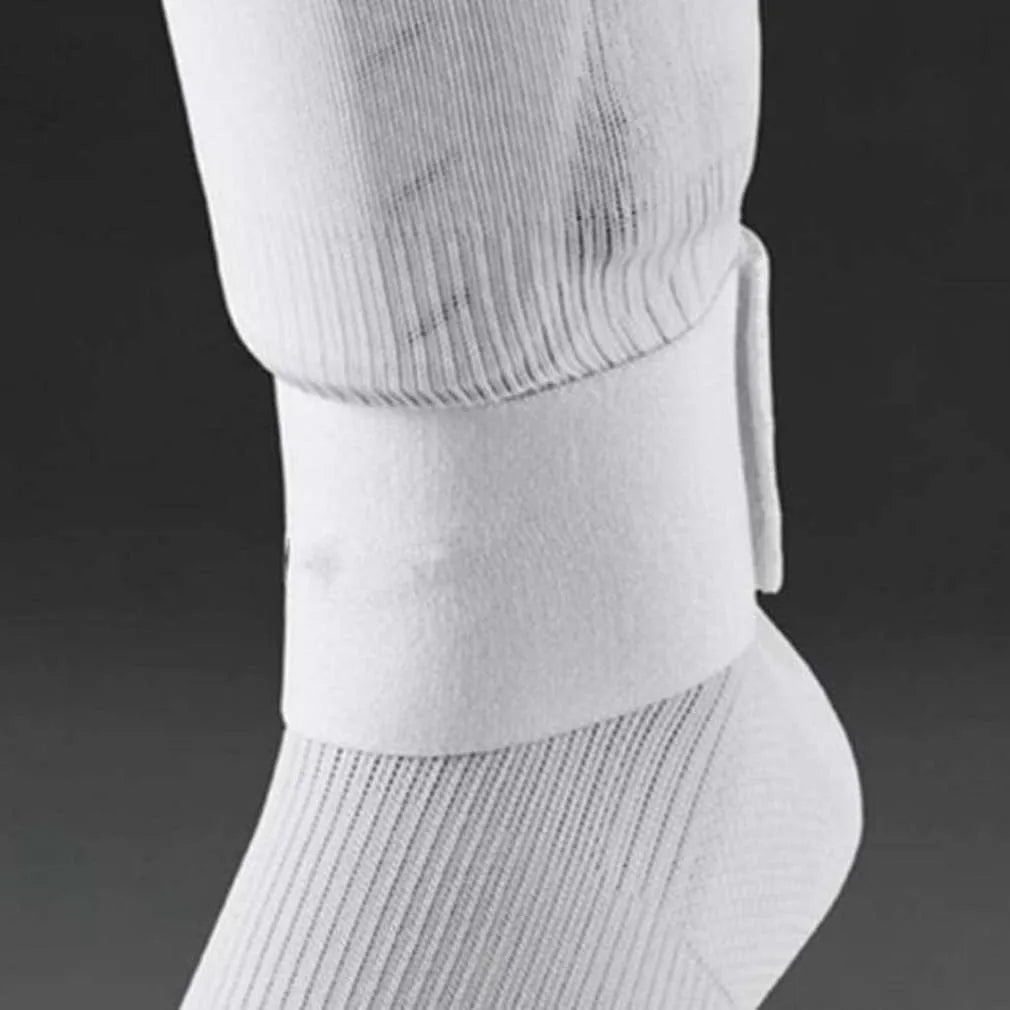Rubber shin guard fixing strap in red, shown next to a football.