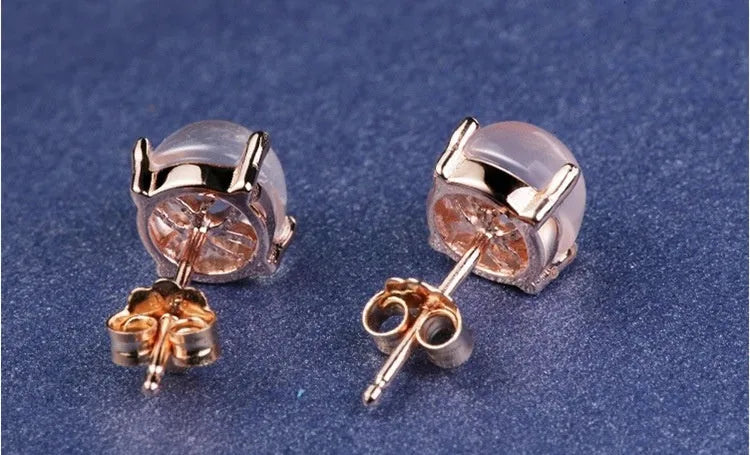 Rose gold drop shape stud earrings with synthetic ross quartz crystal inlay detail
