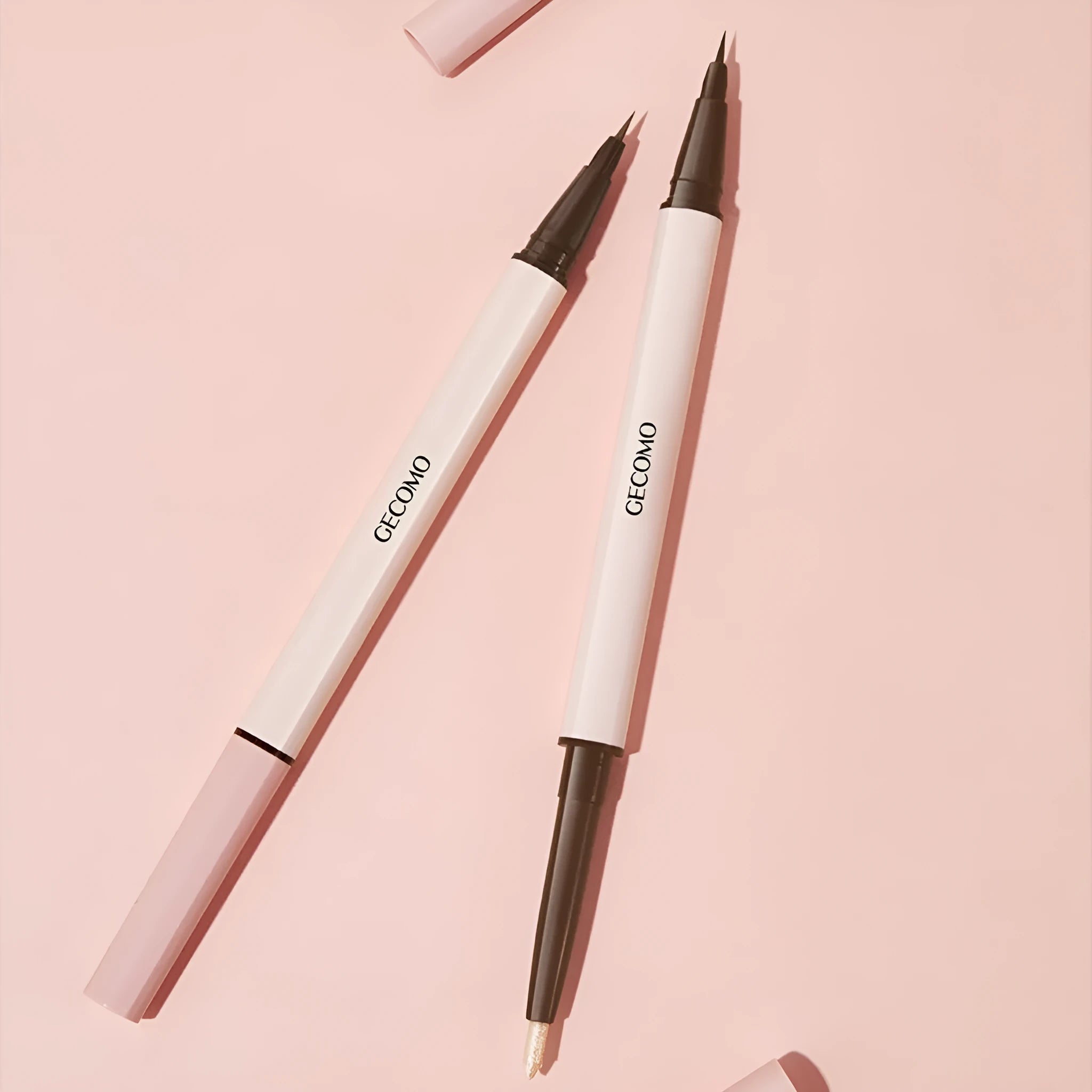 Double headed liquid eyeliner pen with stereoscopic design in pearlescent Floating Platinum and Raw Nude Apricot colours