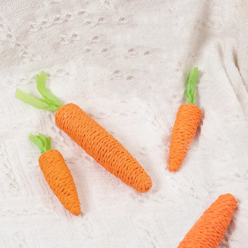 Set of cat toys including carrot-shaped bites, paper toys, ringing stones, and grinding sticks in two sizes.