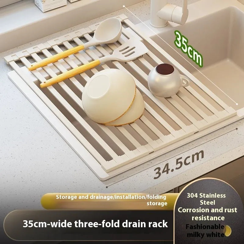 Milky white foldable stainless steel kitchen draining rack next to a sink.