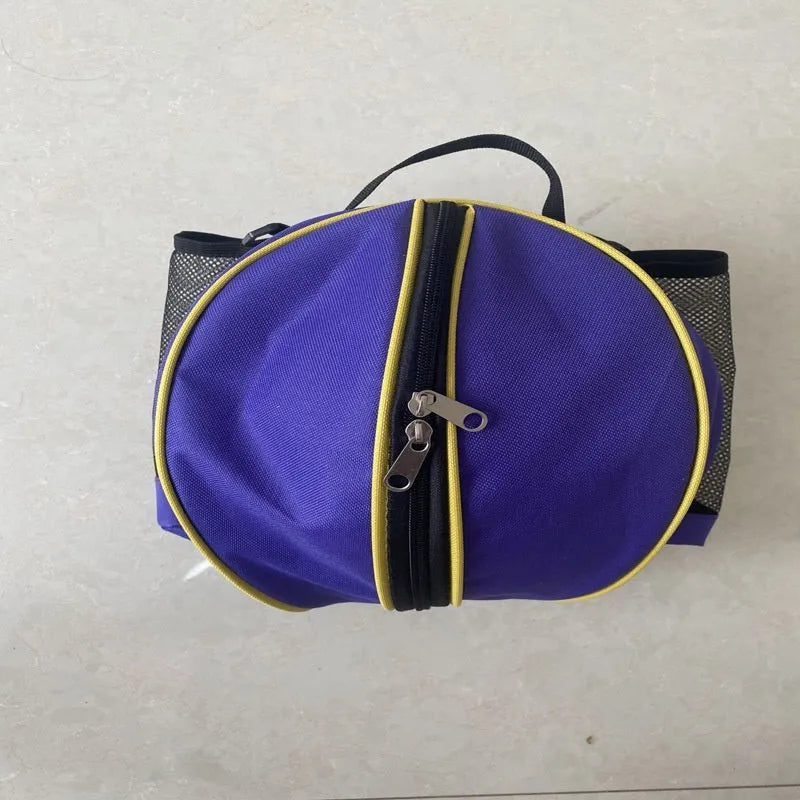 Black Oxford cloth basketball training bag with a single shoulder strap, shown next to a basketball.