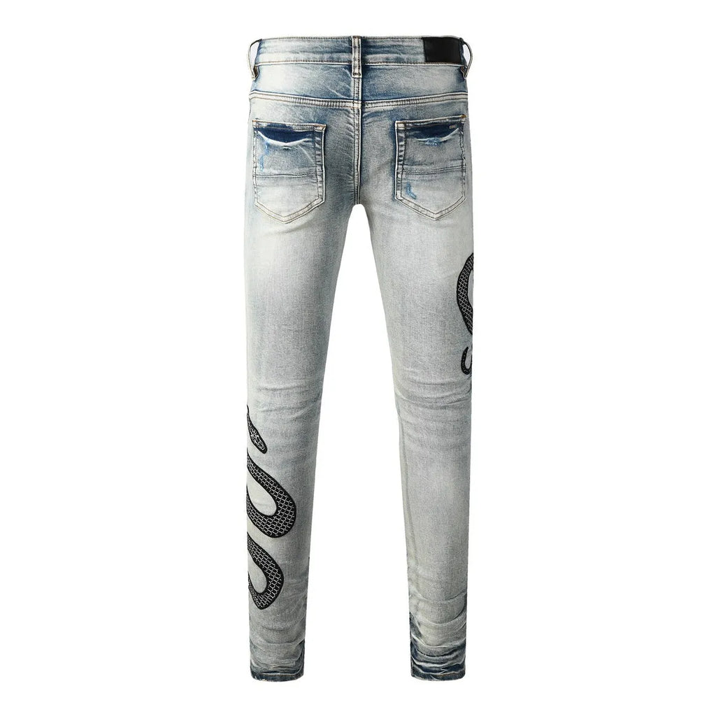 Blue distressed skinny jeans with a mid-waist and button-fly opening on a neutral background.