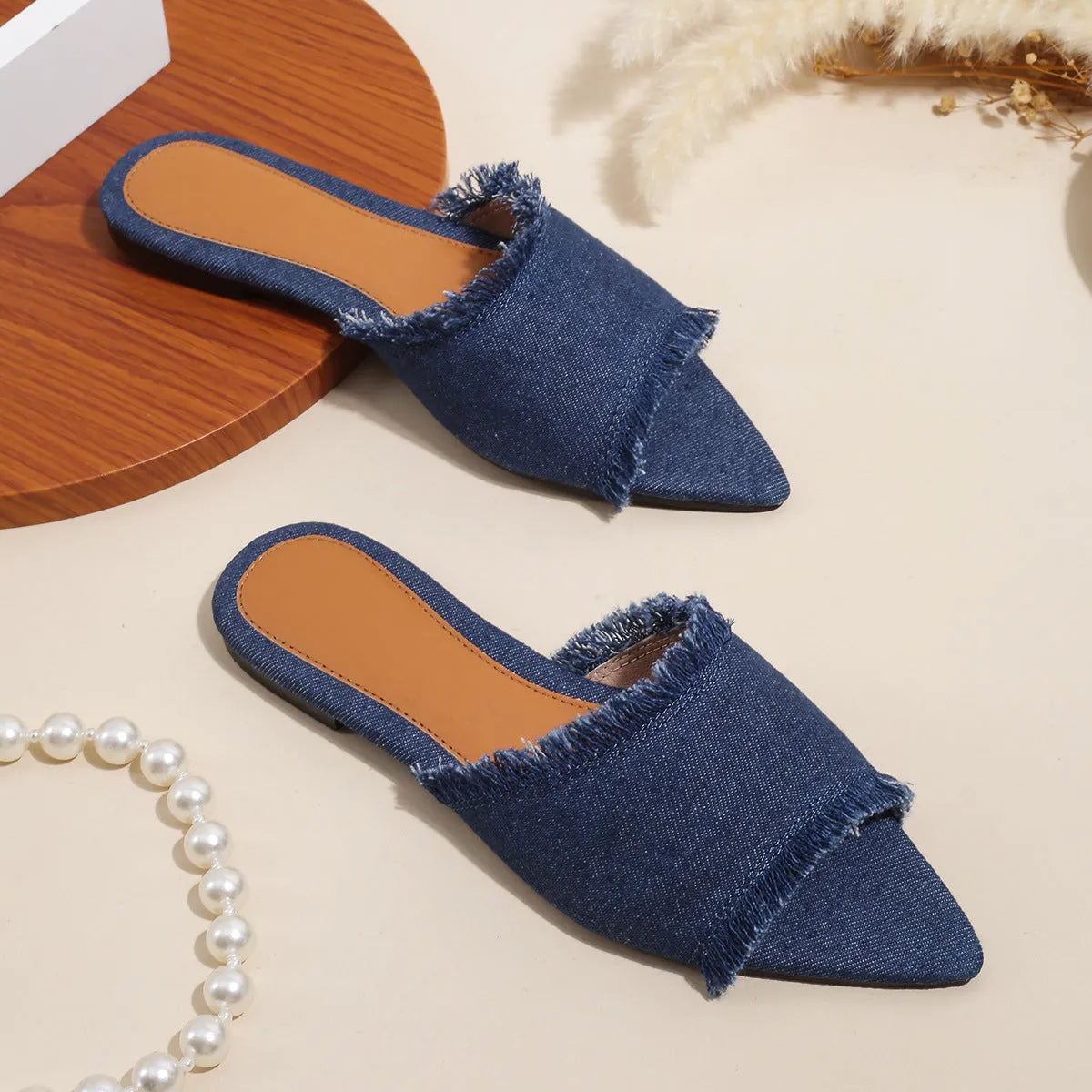Women's denim casual flat slippers with a tassel detail in multiple colour options.