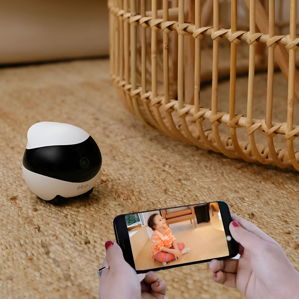White smart home mobile surveillance robot camera on floor with docking station