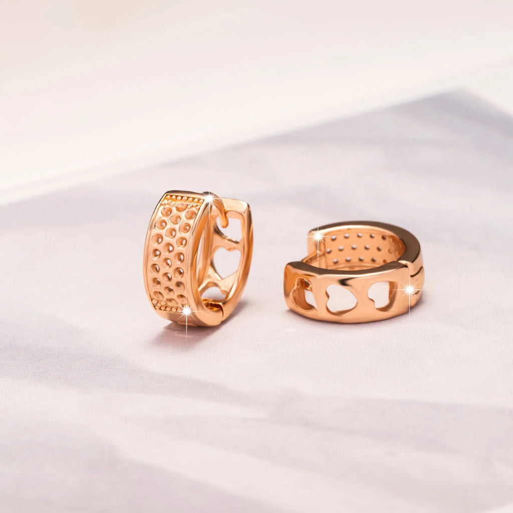 Rose gold women's earrings with a hollow heart shape and circular silhouette.