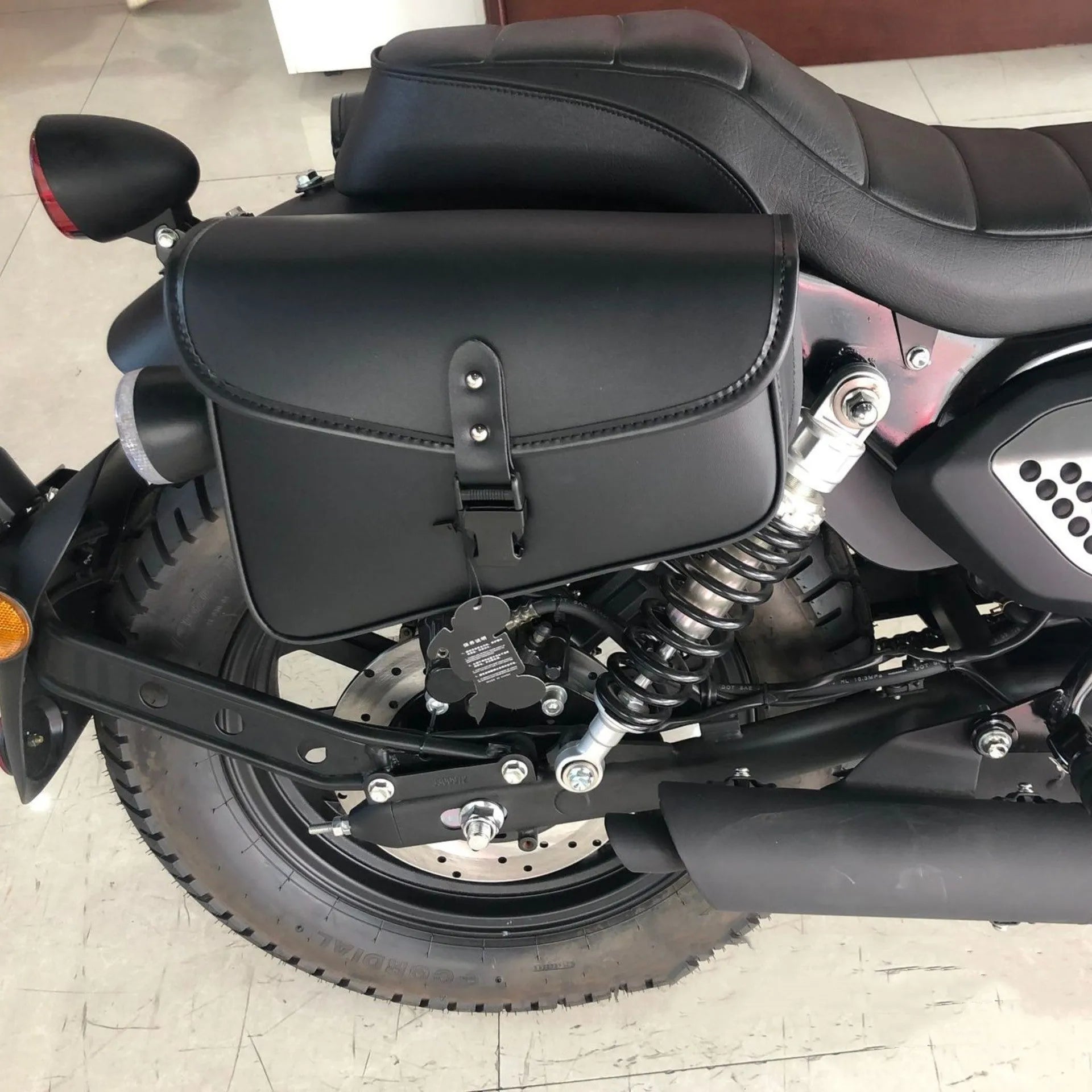Black motorcycle swingarm side saddlebag mounted on Sportster motorcycle