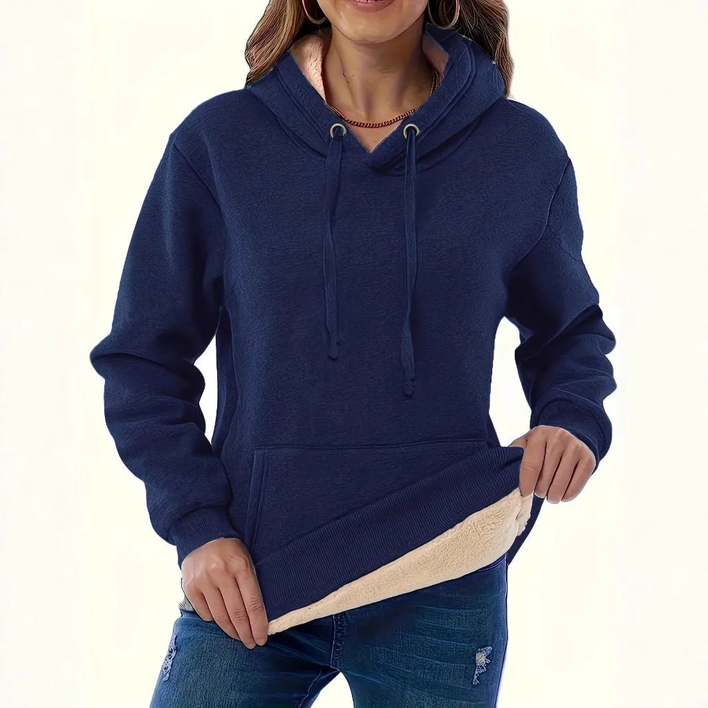 A women's loose fit hooded sweater in thick grey polyester with side pockets and long sleeves.