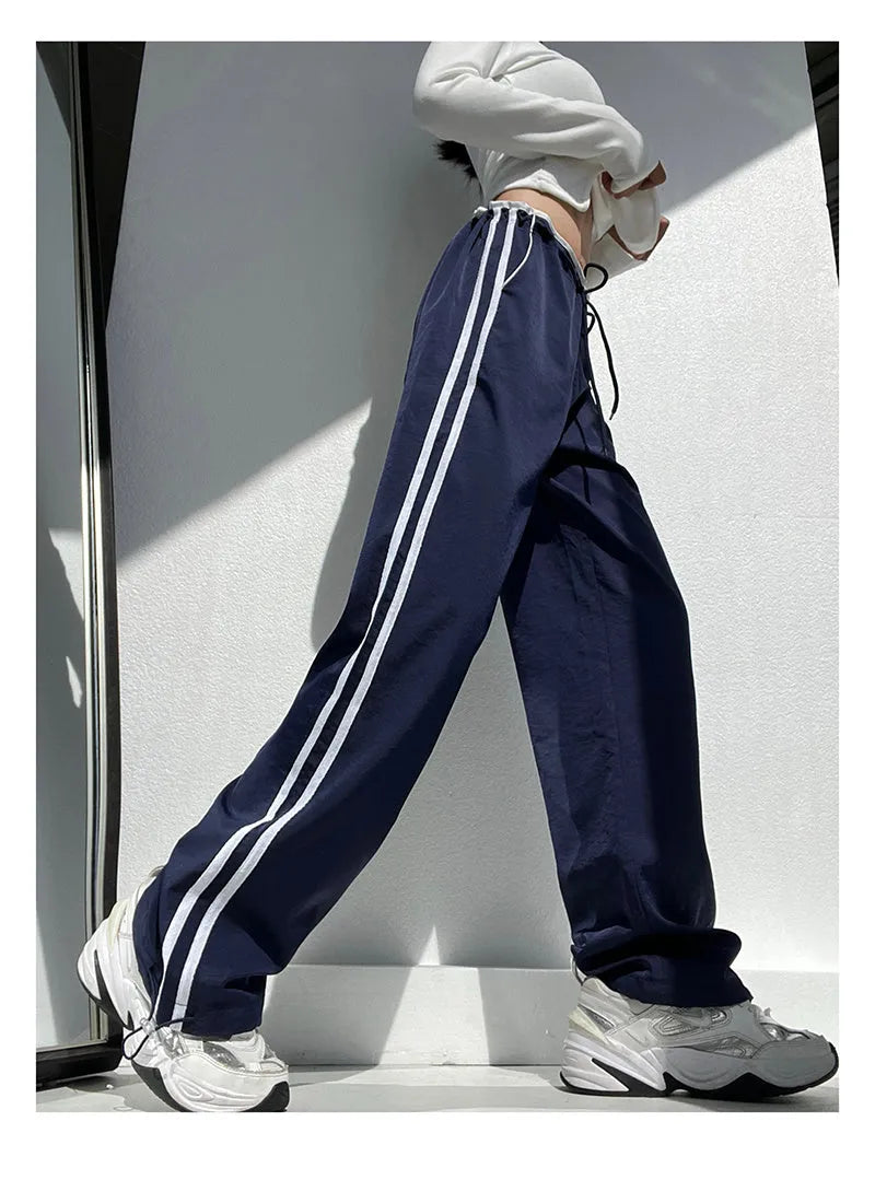 Women's straight leg trousers with ribbon waist and parallel bars contrast detailing in navy blue