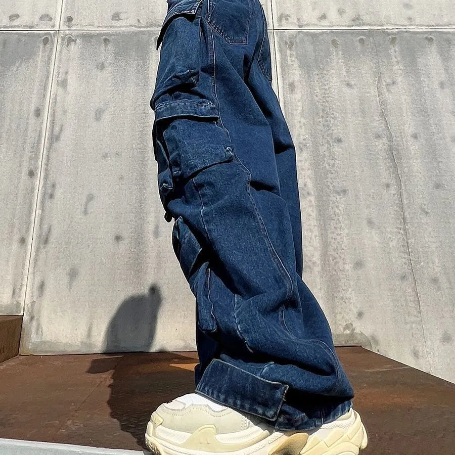 Dark blue distressed wide-leg jeans with a high waist and multiple pockets on a model.