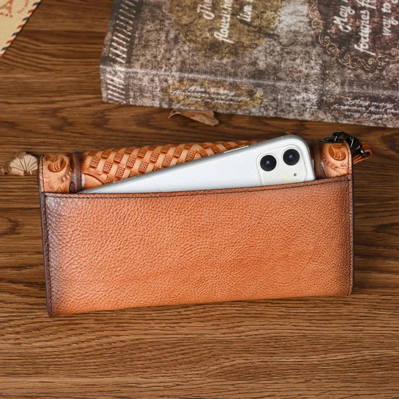 Retro brown floral embossed tri-fold leather wallet open to show interior compartments.