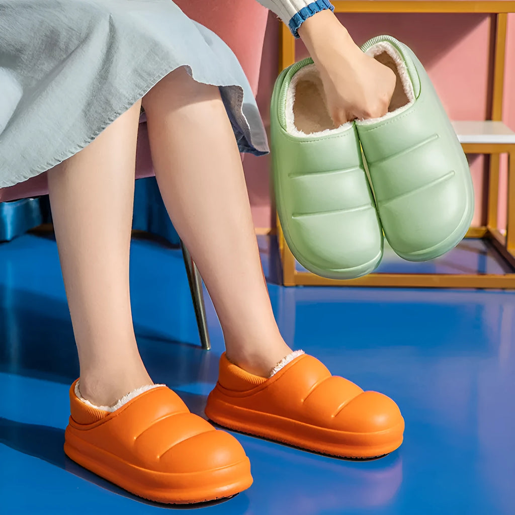 Women's green waterproof EVA winter slippers with plush lining and a non-slip sole.