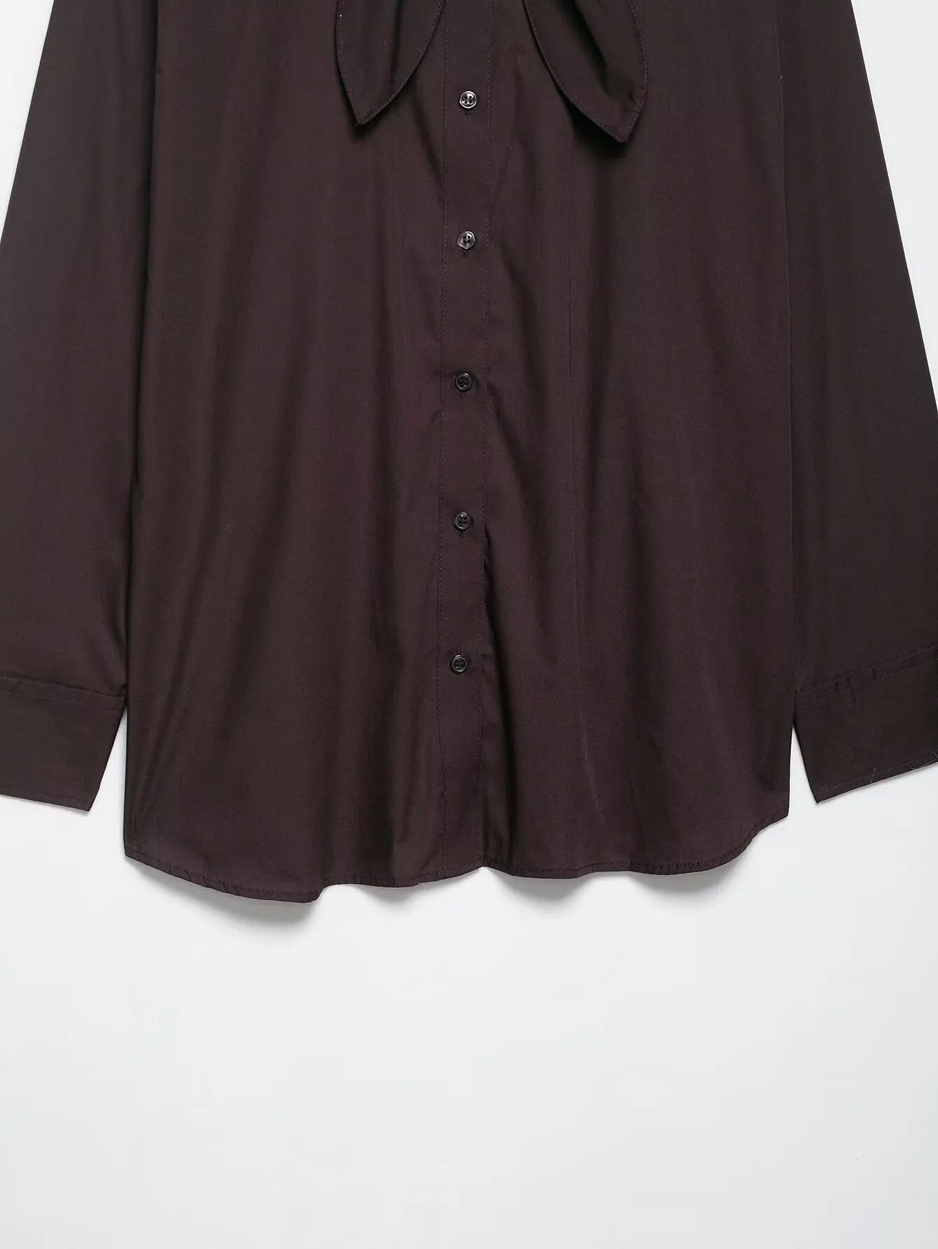 Brown women's loose-fit poplin shirt with long sleeves, cardigan style, and a bow tie detail.