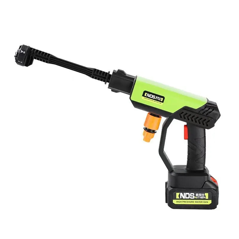 Green cordless high-pressure water gun with multiple nozzle attachments and extension rod on a patio.