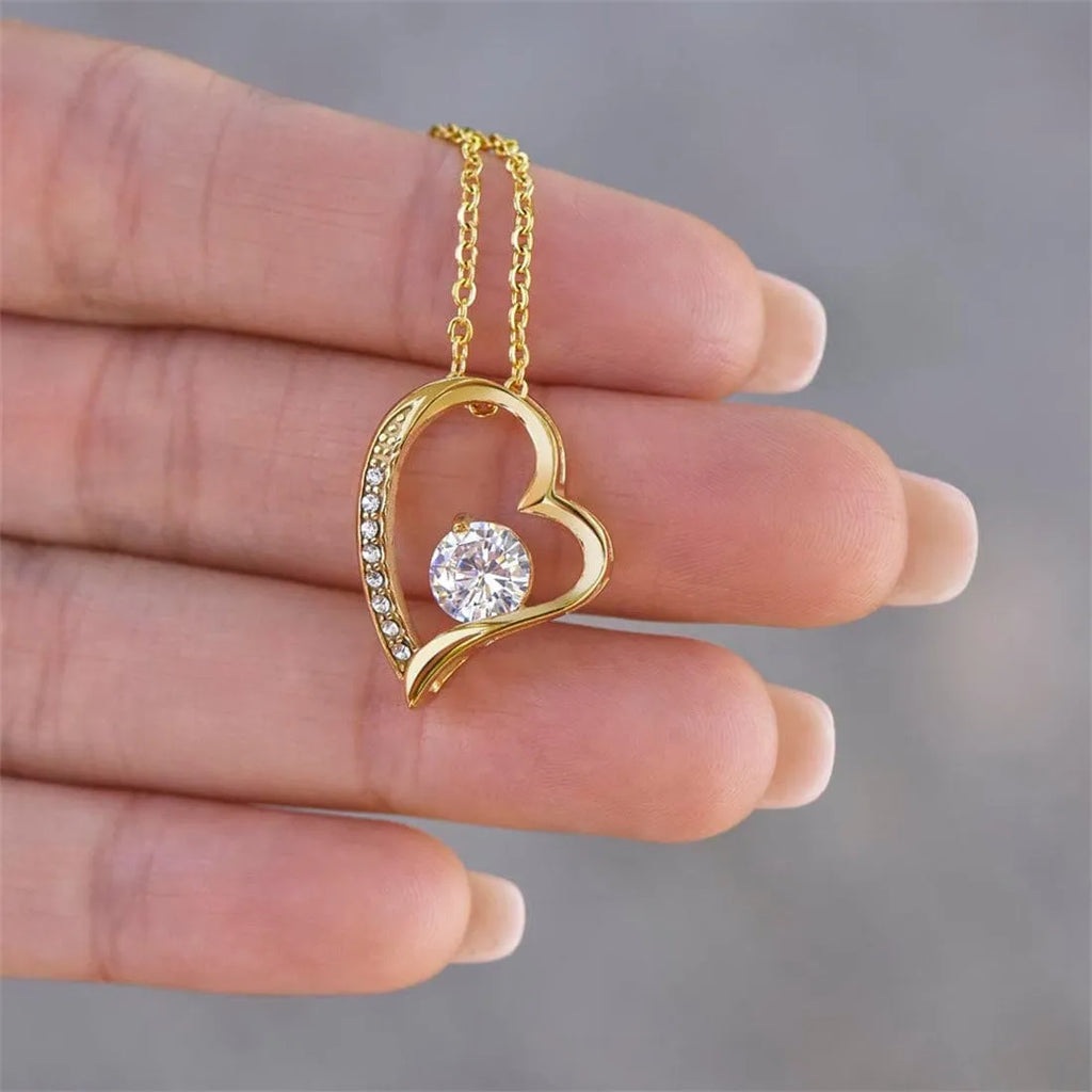 Gold hollow heart pendant necklace presented in an open flip gift box with a card.