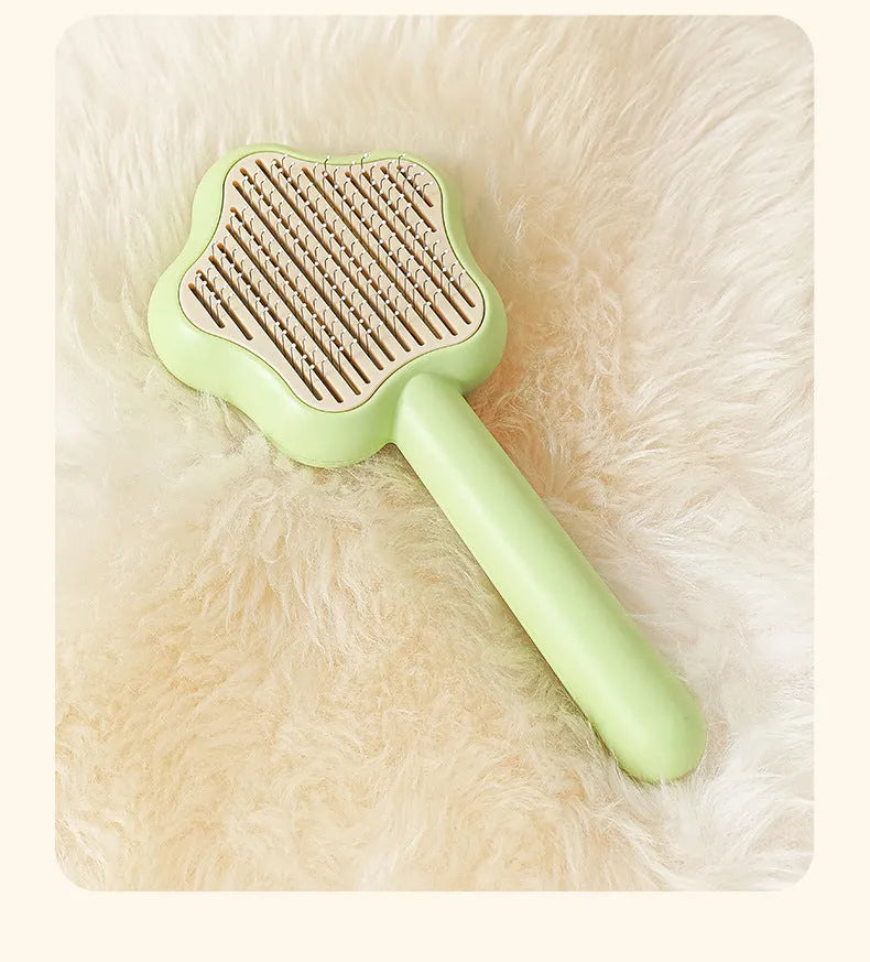 Self-cleaning stainless steel cat comb in green colour measuring 20cm long by 9.5cm wide