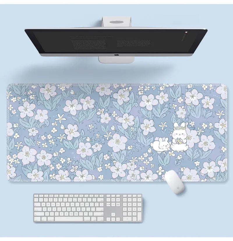 Large floral cartoon pattern mouse pad on a desk, showing non-slip rubber base and colourful design.