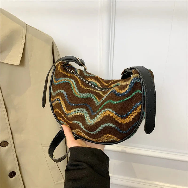 Women's woven straw crossbody bag showing internal phone pocket and file compartment