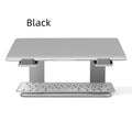 Black aluminium alloy laptop stand on a desk, elevating a silver laptop.