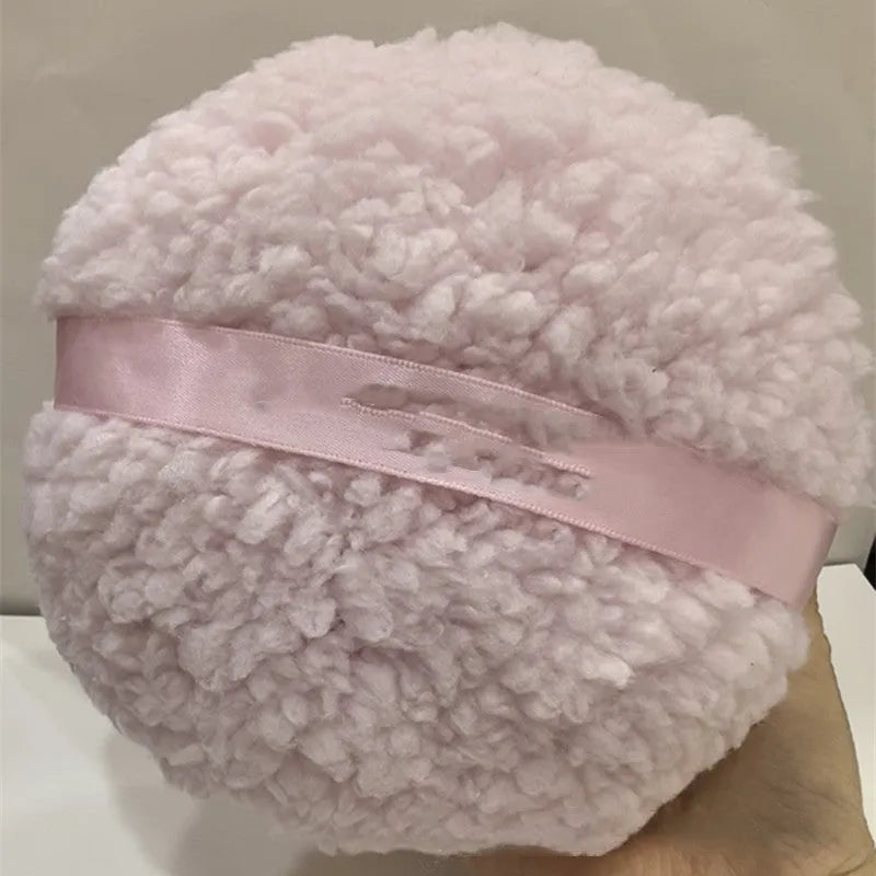 Oversized plush makeup powder puff in white, shown with dimensions 150mm by 75mm