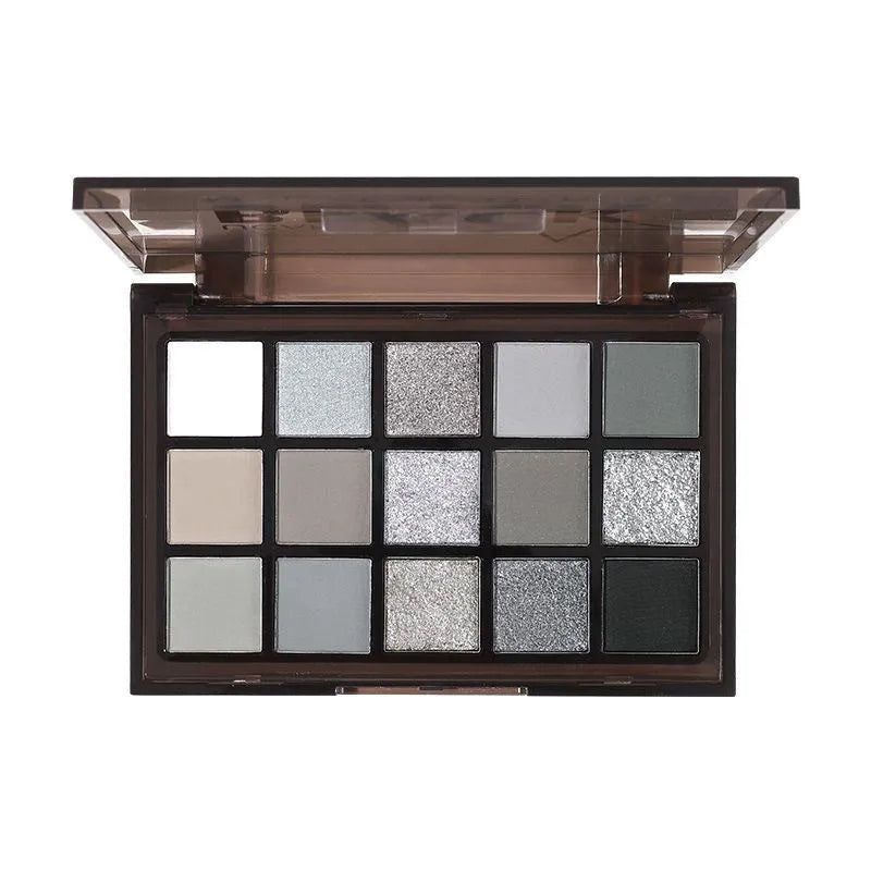Open 15-colour eye shadow palette showing pans of brown, blue, and grey matte and shimmer shades.