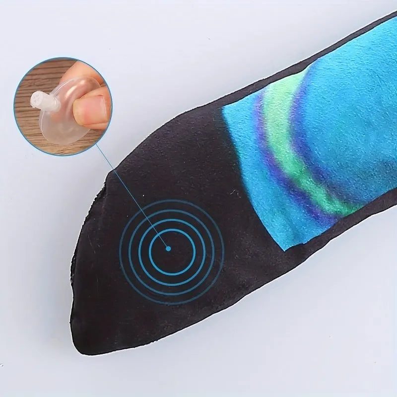 Snake-shaped plush dog squeak toy with rainbow stripe print for chewing and interactive play