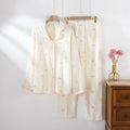 Women's cotton pajama set in pink colour with long sleeves and trousers on hanger