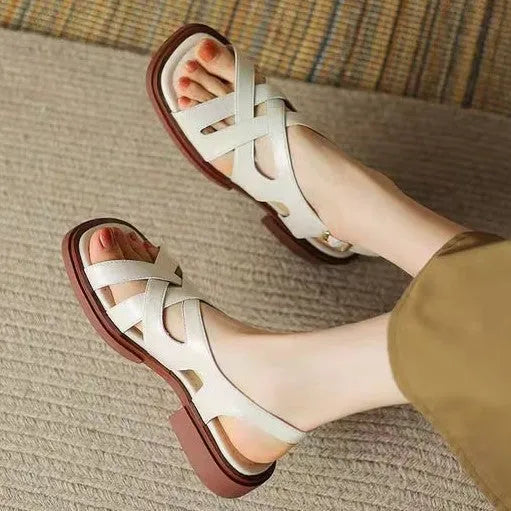 Women's glossy patent leather low heel sandals with square toe and cross-strap in black, brown and white.