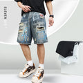 Blue men's ripped denim shorts with a graffiti pattern and zipper fly, laid flat.