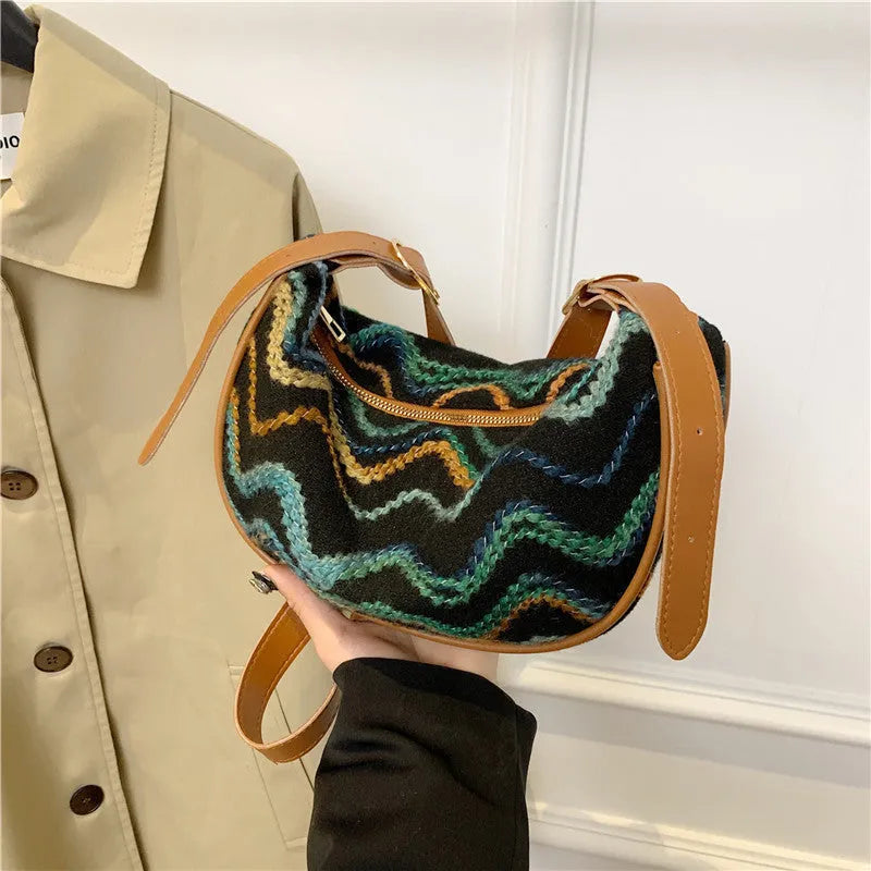 Women's woven straw crossbody bag showing internal phone pocket and file compartment