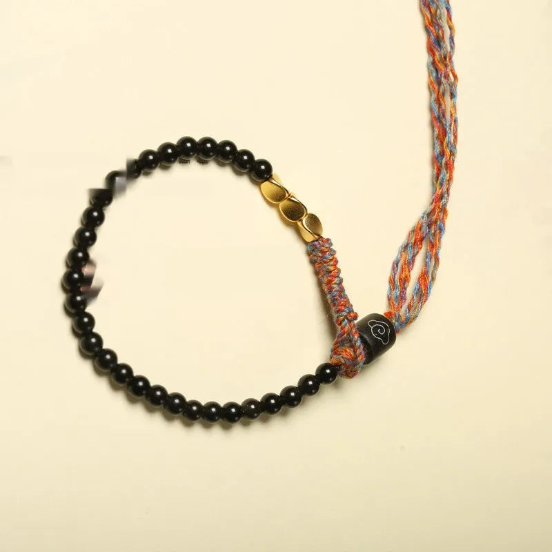 Hand-woven obsidian carrying strap bracelet showing woven texture and 4mm width