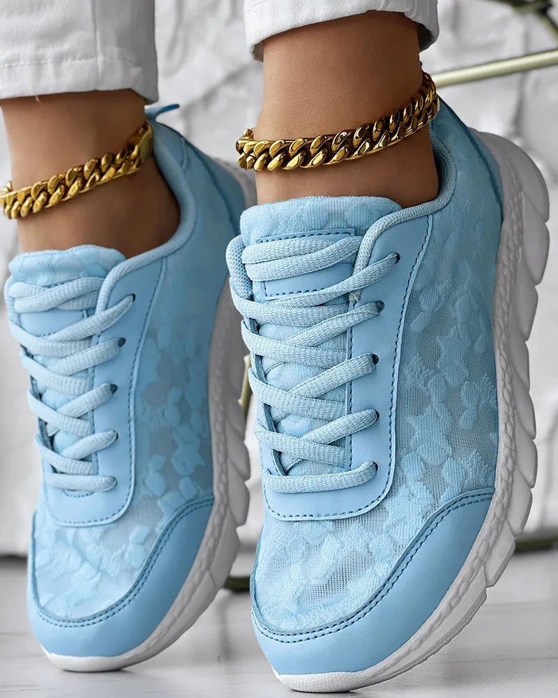 Women's canvas running shoes in white, black, blue, and pink colours with flat heel design