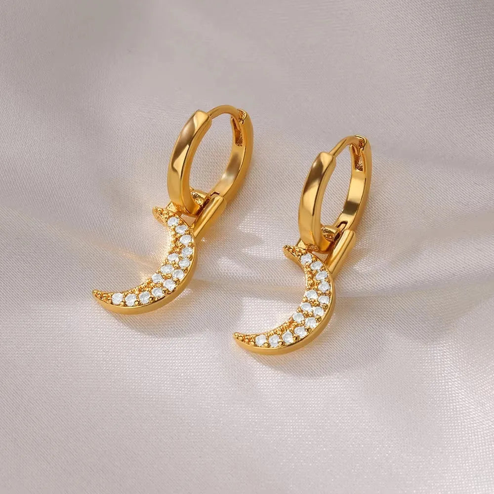 Butterfly-shaped copper earrings with geometric heart, star and bow patterns in metallic finish