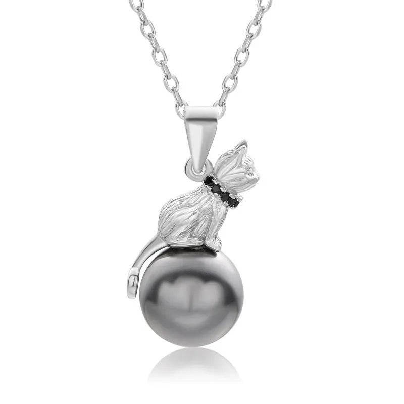 Close-up of a sterling silver cat silhouette pendant on a delicate silver chain.