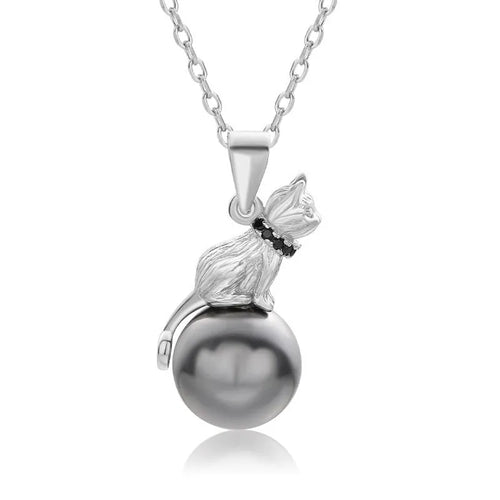 Close-up of a sterling silver cat silhouette pendant on a delicate silver chain.