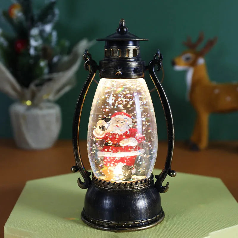 Portable crystal ball oil lamp Christmas ornament showing light-emitting snowman or elderly figure design on a desk.