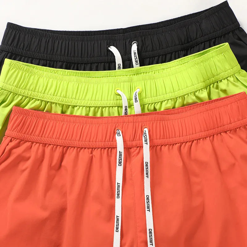 Men's loose beach surfing shorts in quick-dry polyester available in orange, green, and black
