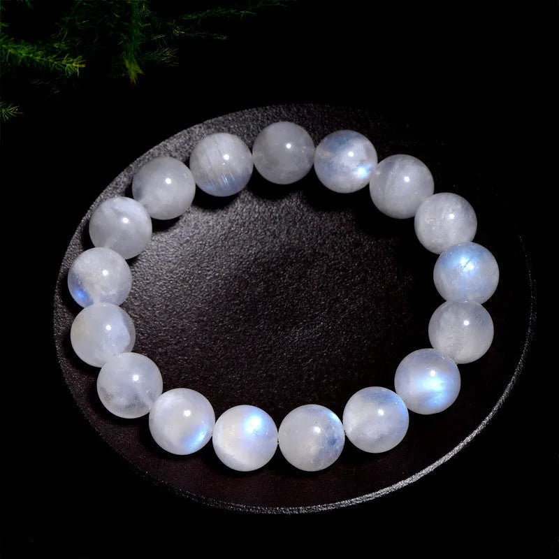 Natural blue moonlight round moonstone bead bracelet on wrist showing polished surface