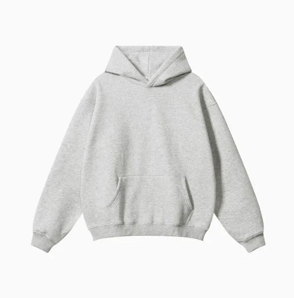 Man wearing a loose-fit grey cotton hooded sweater with drop-shoulder sleeves.