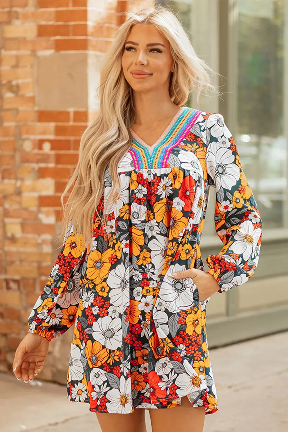 Orange floral print striped lace V-neck long sleeve mini dress on a hanger
