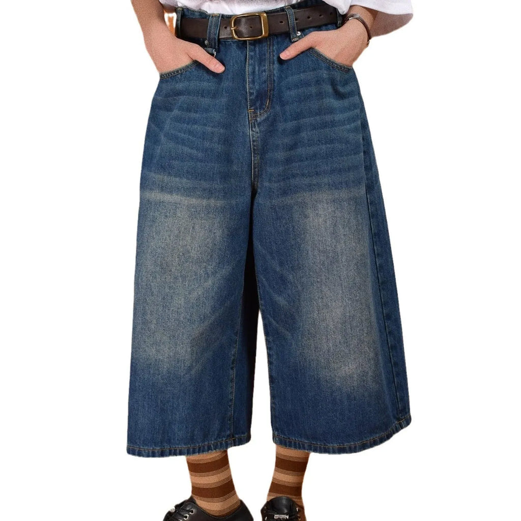 Man wearing blue loose straight-leg denim shorts with a simple summer style.