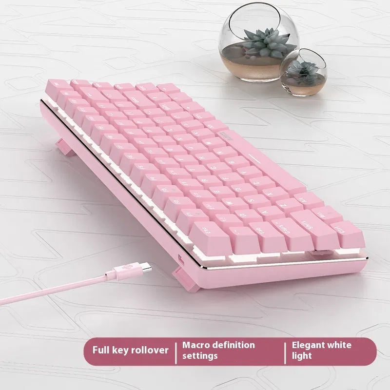 82-key mechanical keyboard with white backlight and metal construction beside laptop