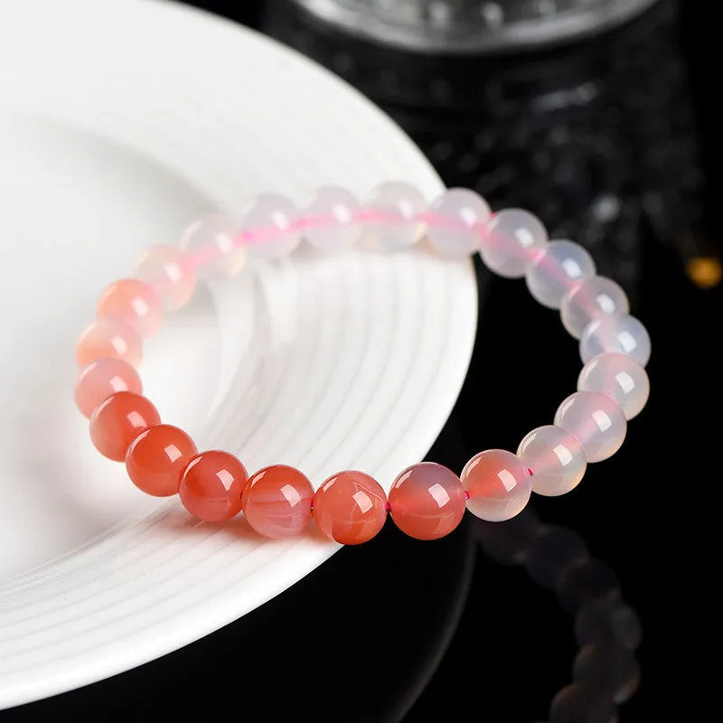 Natural gradient colour agate bracelet with geometric beads on a wrist.