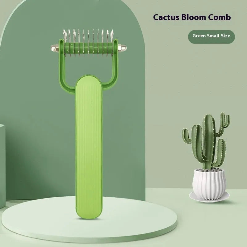 Green and grey dog hair unknotting comb with stainless steel teeth on a plastic handle.
