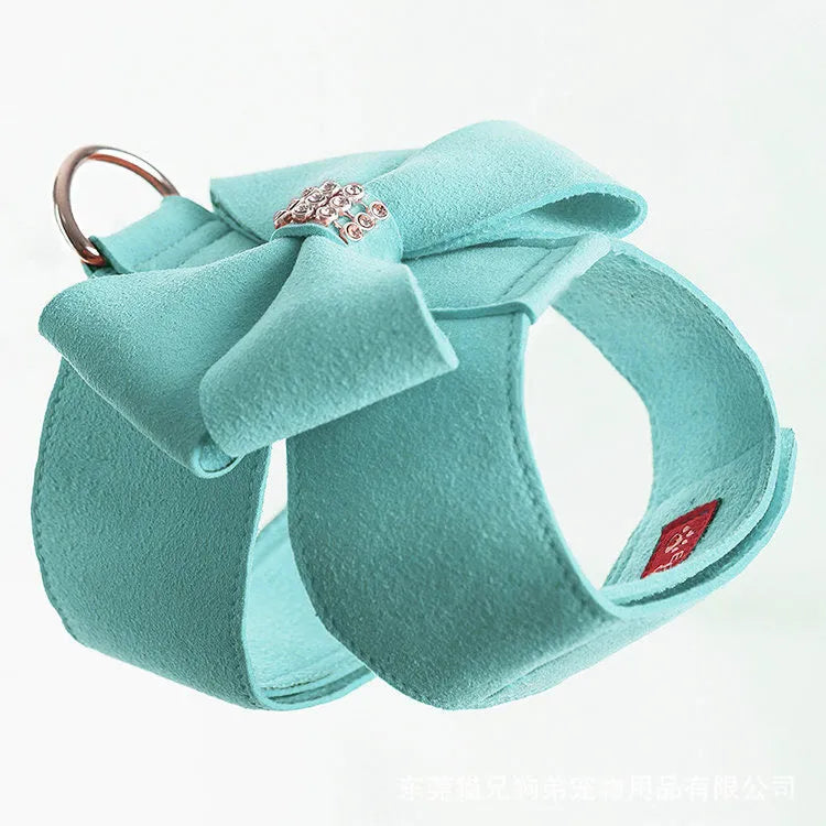 Dog wearing microfiber chest strap with decorative bow knot in blue colour