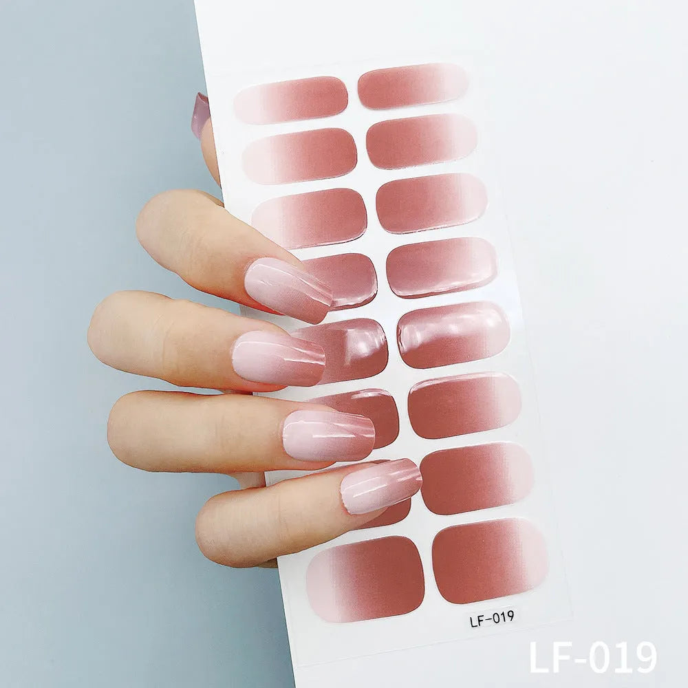 Set of 16 solid colour nail art stickers showing floral, geometric, and pattern designs for manicure application