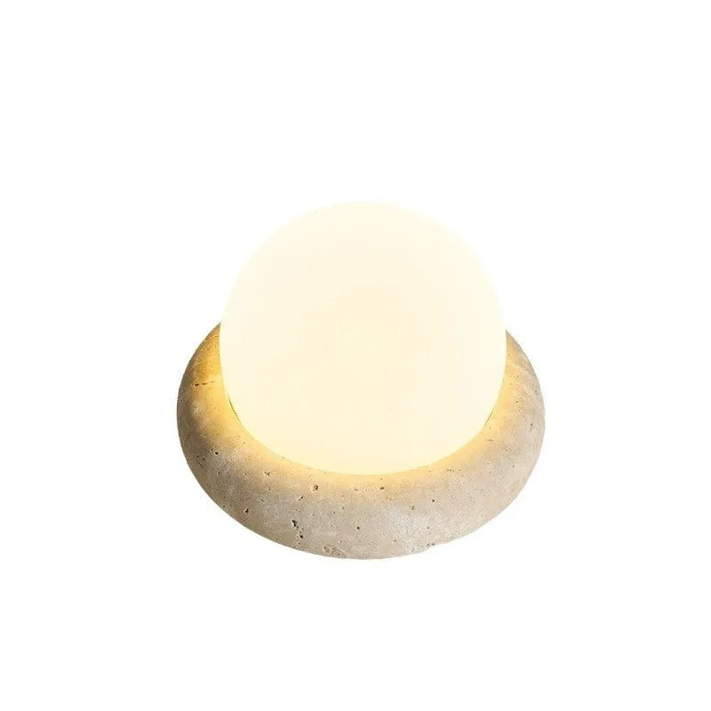 Cream-coloured modern bedside night lamp with remote control on wooden table