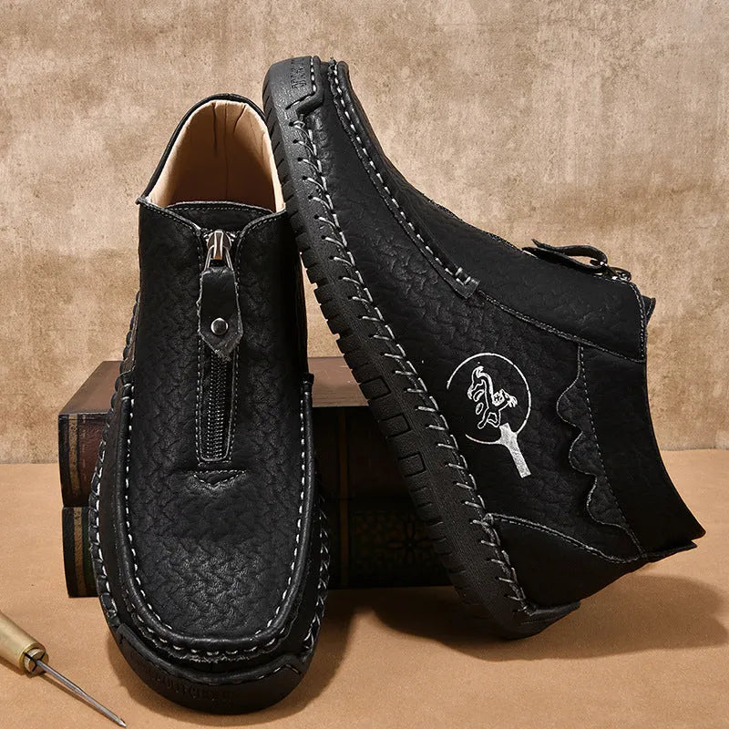 Men's black slip-on leather loafers with a round toe and rubber sole on a white background.