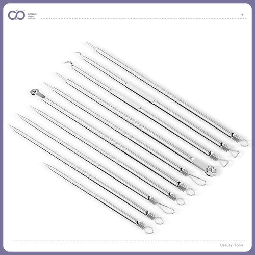 Four metal acne needles with pointed tips arranged on a clean surface.